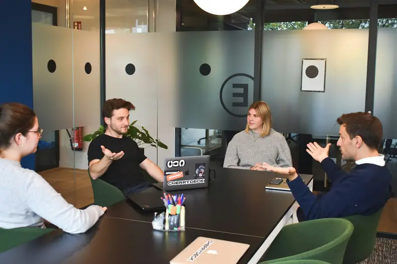 An agency team talking through a project in a meeting room